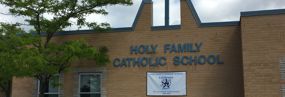 Exterior of Holy Family Catholic School with banner saying, "Holy Family Catholic School Celebrates 25 years in Catholic education".